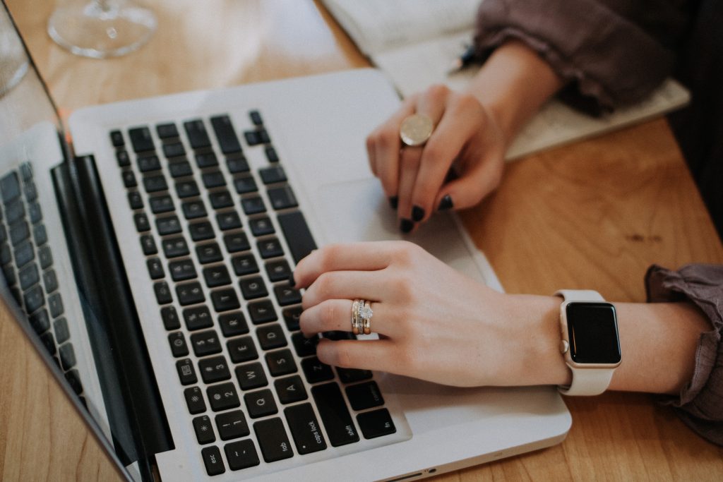 Image of a womans hands working on a computer.