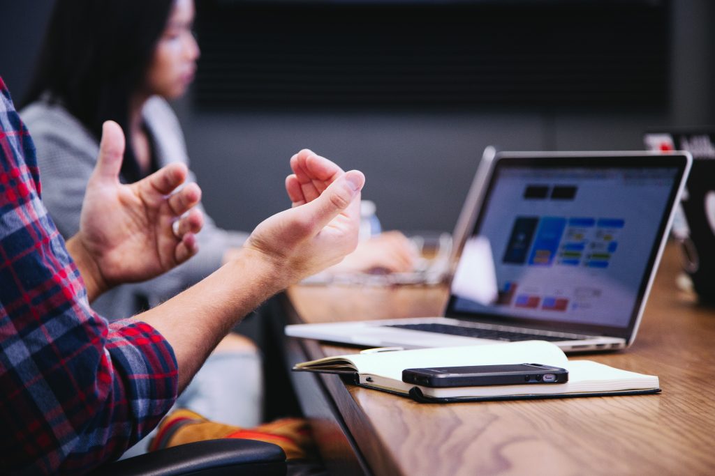 Two entrepreneurs looking at project management apps on the computer together.