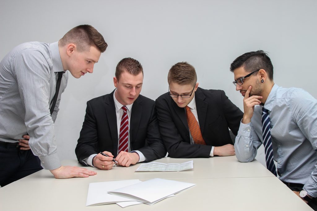 A group of people reviewing financial assistance documents.