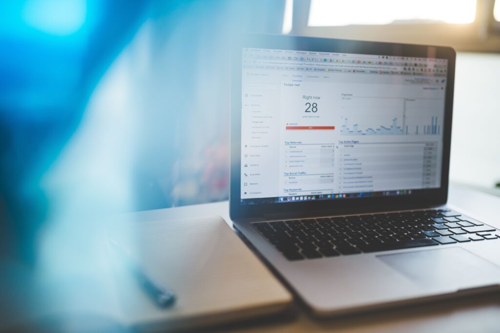 Laptop displaying a Google Analytics dashboard with website traffic and performance data.